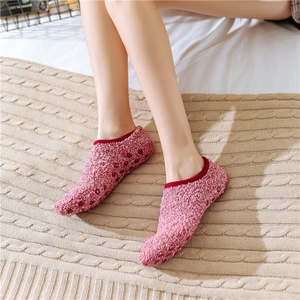 Detailed view of pink coral fleece floor socks with anti-slip silicone dots on soles