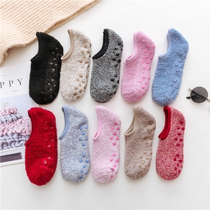 Close-up of non-slip silicone grippers on plush coral fleece slipper socks sole