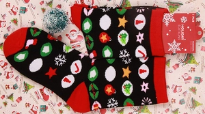 Close-up of Christmas themed holiday socks with festive patterns and holiday packaging