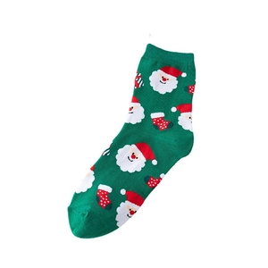 Christmas socks in green with Santa Claus and polka dot patterns, knitted cotton mid-calf style
