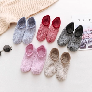 Flat lay of five pairs of thick plush coral fleece socks in varied warm winter colors