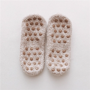 Detail of anti-slip silicone dots and plush fleece texture on winter floor socks