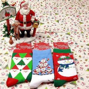 Set of festive Christmas themed cotton knit socks with Santa and Snowman holiday patterns