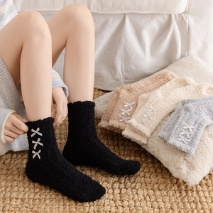 Plush coral fleece thermal socks for women with ribbon bow accents for winter warmth