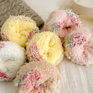 Close-up of soft coral fleece socks in pastel colors with warm plush texture details
