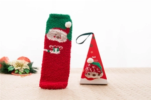 Detailed view of plush coral fleece Christmas socks with 3D pompoms and a festive gift box