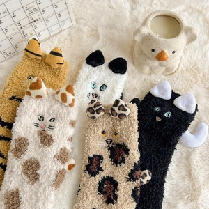 Cozy coral fleece women socks featuring cartoon cat ears and leopard patterns on soft rug