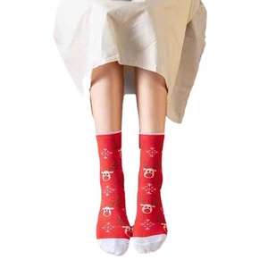 Festive red and white Christmas crew socks featuring knitted reindeer and snowflake patterns