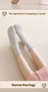 Detail of grey plush crew socks with cable knit texture for cozy winter home wear