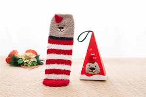 Detail of coral fleece Christmas socks with bear embroidery and matching gift box