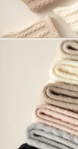 Detailed cable knit texture of thick thermal winter socks in various earthy colors