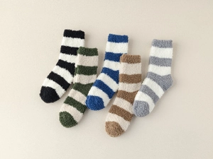 Close-up of five pairs of thick striped coral fleece warm socks in various colors