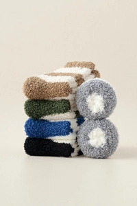 Close-up of thick coral fleece socks with multi-color striped patterns for winter warmth