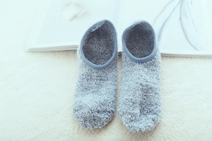 Detailed view of light blue plush floor socks made of soft coral fleece for indoor yoga