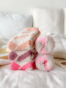 Detail of soft coral fleece socks showing thick striped texture in pastel colors