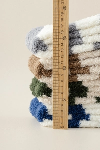 Close-up of four stacked thick coral fleece socks measuring 19cm in height