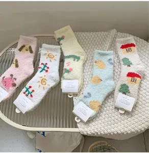 Dettaglio di cinque paia di calze spesse in pile corallo con motivi di animali colorati