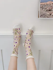 Détail de chaussettes en maille respirante avec broderie florale et dentelle