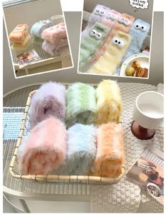 Close-up of fluffy coral fleece socks with colorful macaron tones and cute 3D eye decor