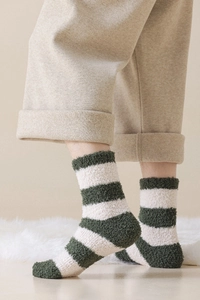 Detail of soft green and white striped coral fleece socks with plush thermal texture