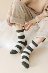 Detail of green and white striped coral fleece socks for winter indoor warmth