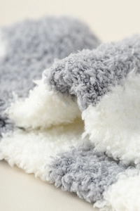 Close-up of thick grey and white striped coral fleece fabric with soft plush texture