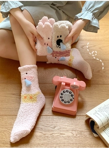 Detailed view of thick coral fleece winter socks with 3D animal ears and cozy texture