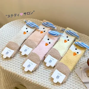 Detailed view of five pairs of warm coral fleece socks with cute cartoon chick embroidery