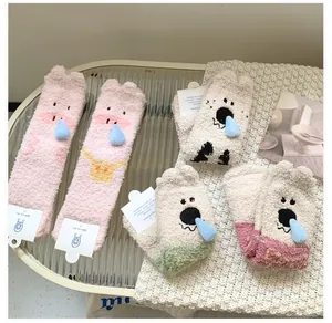 Detail of cute coral fleece thermal socks featuring 3D cartoon animal character designs