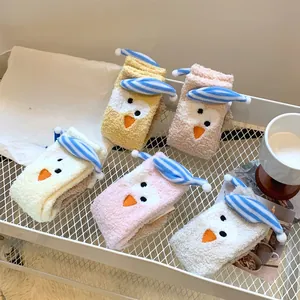 Detail of five pairs of thick coral fleece thermal socks with cute 3D hat ornaments
