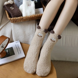 Detailed view of thick plush sleep socks with cartoon monster embroidery and soft 3D ears