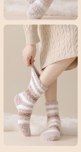 Close-up of thick coral fleece striped socks with soft texture and cozy thermal material