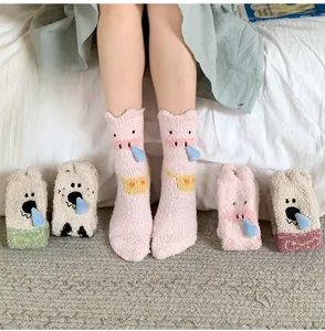 Detail of soft coral fleece socks featuring cute animal faces and thick thermal texture