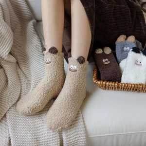 Detail of plush coral fleece sleeping socks with cartoon embroidery and 3D ears