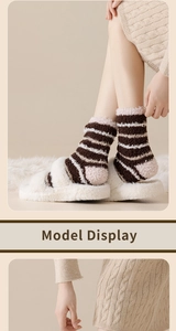 Detail of plush coral fleece striped socks in warm tones for winter indoor comfort