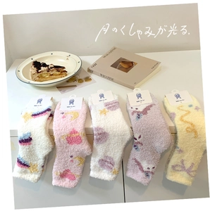 Detailed view of thick coral fleece socks in soft macaron colors with star patterns