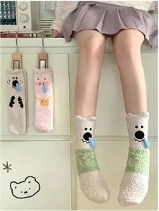 Close-up of thick coral fleece socks with cute 3D cartoon animal patterns for winter warmth