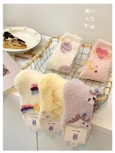 Detailed set of five soft coral fleece socks in a basket with cute embroidered patterns