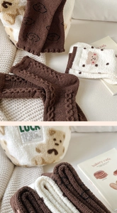 Detailed texture of thick fleece socks with cute bear patterns and plush fabric