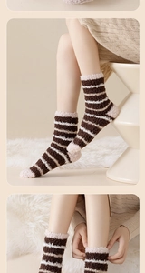 Close-up of thick striped thermal socks with plush cuffs and elastic detail view