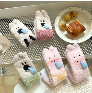 Thick coral fleece thermal socks featuring cute animal patterns in a home basket