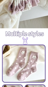 Detailed macro view of soft purple coral fleece socks with cute rabbit embroidery detail