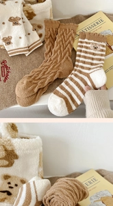 Detail of plush coral fleece winter socks with cute bear patterns and ribbed cuffs