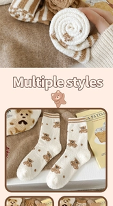Close-up of thick winter coral fleece socks with cute brown bear patterns and soft texture