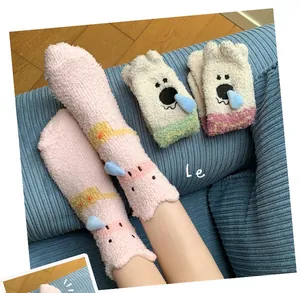 Detailed plush texture of coral fleece thermal socks featuring 3D animal decorations