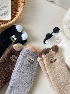 Close-up of cute cartoon thick coral fleece socks in multiple colors with ear details
