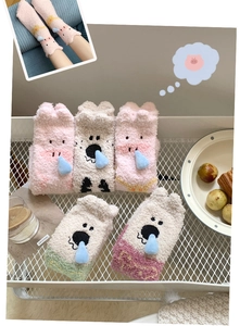 Detailed texture of thick coral fleece warm socks in assorted cute cartoon colors