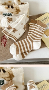 Detail of warm double-sided fleece socks and matching tote with cute bear embroidery