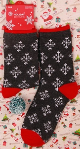 Dark grey festive Christmas crew socks with white snowflake patterns and red heels