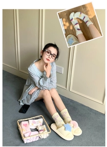 Detailed view of thick coral fleece socks with cute heart and star jacquard patterns